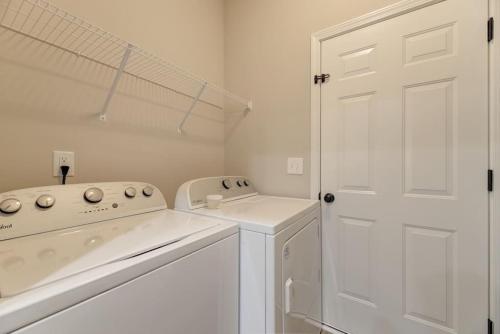 lavadero blanco con lavadora y secadora en Cayce Sister Houses-Sleeps 14 en Cayce