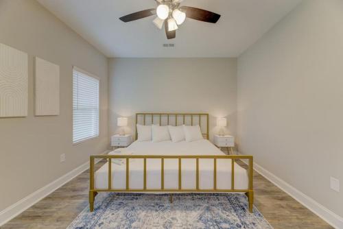 a bedroom with a bed and a ceiling fan at Cayce Sister Houses-Sleeps 14 in Cayce