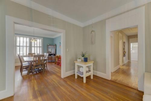 a dining room and living room with a table and chairs at Rose Hill Retreat-Mins to USC in Columbia