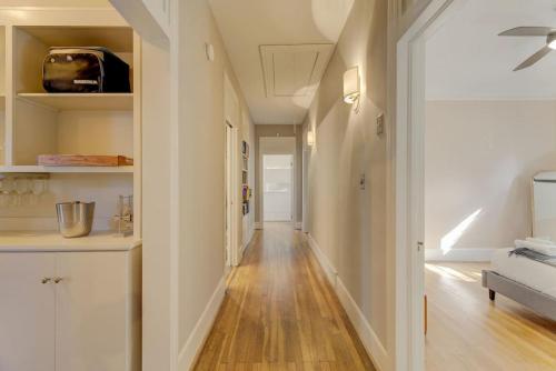 a hallway of a home with white walls and wood floors at Rose Hill Retreat-Mins to USC in Columbia