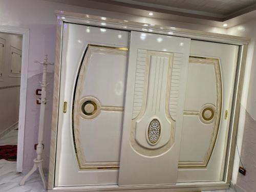 a white door with a window in a room at Cozy Flat near downtown Almorsi in Alexandria