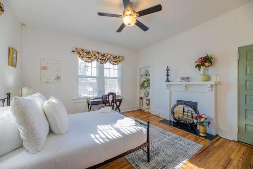 a living room with a white couch and a ceiling fan at Heidt of Cola-Behind 5 Points in Columbia