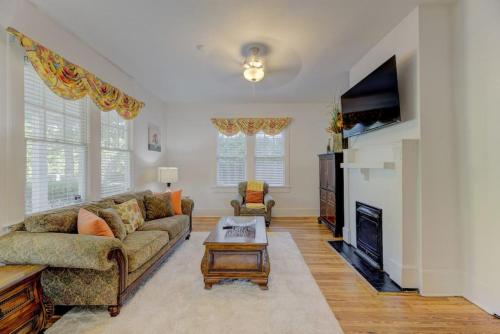 a living room with a couch and a fireplace at Heidt of Cola-Behind 5 Points in Columbia