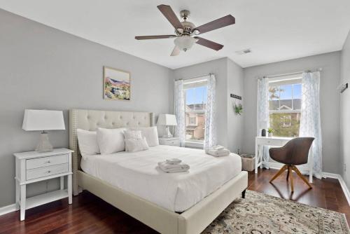 a bedroom with a white bed and a ceiling fan at Contemporary 3BR in Columbia