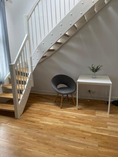 a staircase with a chair next to a table and a desk at Private Rom for two in Oslo City center-Main Street-Walking distance in Oslo