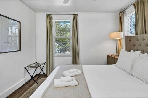 a bedroom with a large bed with two towels on it at Modern Gem in Columbia in Columbia