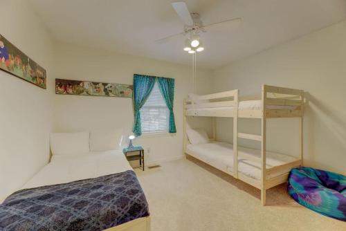 a bedroom with two bunk beds and a ladder at Brick and Blue - Mins to USC in Columbia