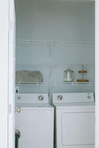 a kitchen with a white stove and a dishwasher at The Congaree Cottage in Cayce