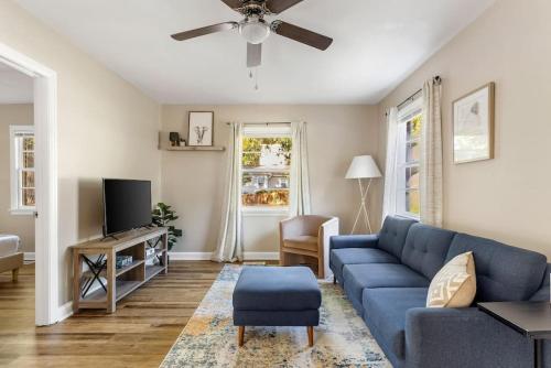 a living room with a blue couch and a tv at Humble Home on Harrison in Columbia