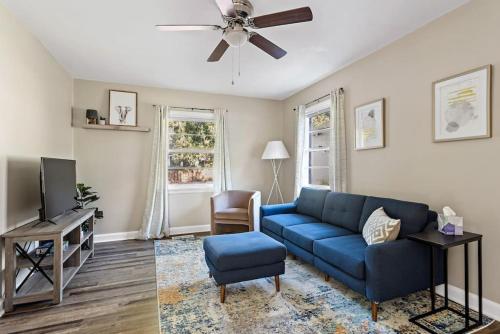 a living room with a blue couch and a tv at Humble Home on Harrison in Columbia