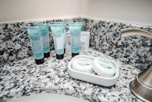 a bathroom counter with toothbrushes and cups of toothpaste at Fun 4BD w 75 inch TV in West Columbia