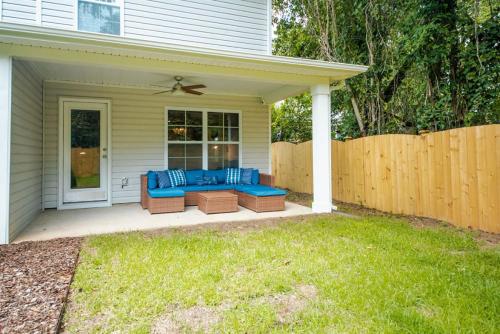 a patio with a blue couch on a house at Fun 4BD w 75 inch TV in West Columbia