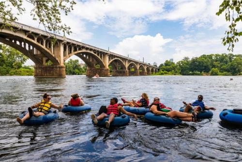a group of people tubing down the river in rafts at Fun 4BD w 75 inch TV in West Columbia