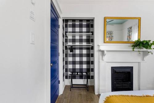 a living room with a fireplace and a mirror at Urban Farmhouse-Sleeps 8 in West Columbia