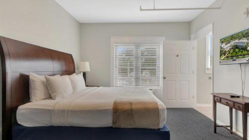 a bedroom with a large bed and a television at Crystal Bay Historic Hotel in St Petersburg