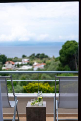 a table and two chairs on a balcony with a view at King Size Villas in Kolios