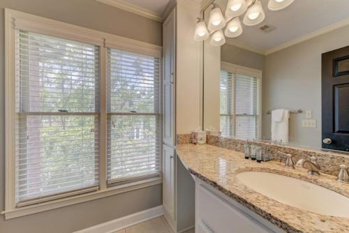 a bathroom with a sink and a large mirror at Trendy Columbia Townhome in Columbia
