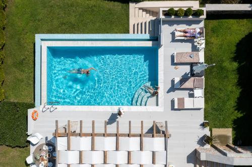 an overhead view of a person swimming in a swimming pool at King Size Villas in Kolios