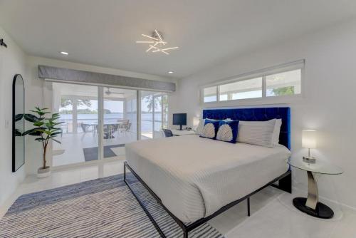 a bedroom with a large bed with a blue headboard at Modern Villa - Lake Views in Lake Murray Shores
