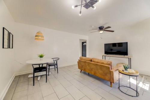 a living room with a couch and a table at Stylish 1 BR Apt Mins to ZOO USC Ft Jackson in Columbia