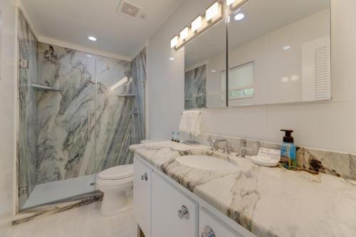 a bathroom with a marble sink and a toilet at Modern Villa - Lake Views in Lake Murray Shores