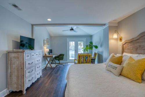 a bedroom with a bed and a dresser and a desk at Lake Murray Lakeshore Lodge in Lake Murray Shores