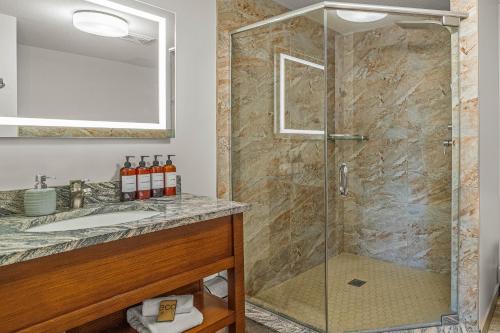 a bathroom with a shower and a sink at Romantic Mountain Escape - Hot Tubs & Private Balcony! managed by Little Sister Getaways in Canmore