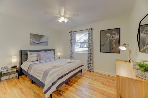 a bedroom with a bed and a ceiling fan at Modern Renovated Apartment in Columbia