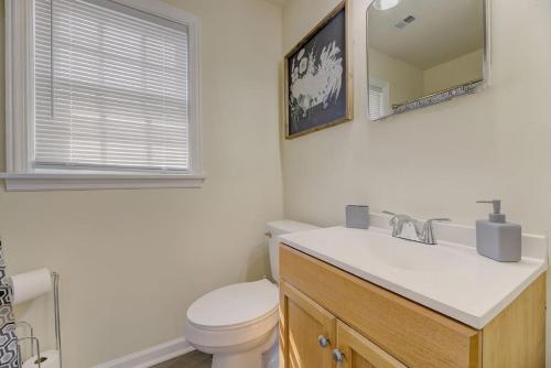 a bathroom with a toilet and a sink and a mirror at Carolina Crash Pad Upstairs in Columbia