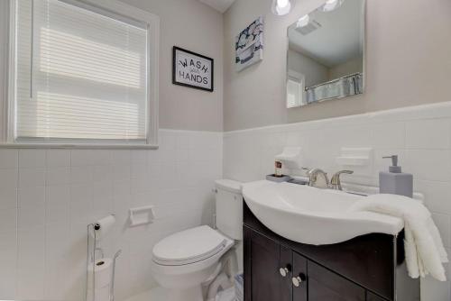 a bathroom with a sink and a toilet and a mirror at Carolina Crash Pad Downstairs in Columbia
