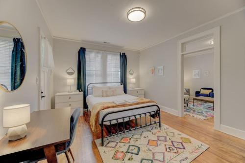 a bedroom with a bed and a table and a desk at The Bruce Apartment in Columbia