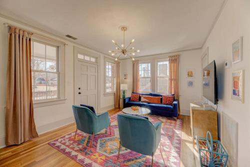 a living room with a couch and a table and chairs at The Jewel of Bull St. Upstairs in Columbia
