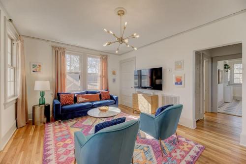 a living room with a blue couch and chairs at The Jewel of Bull St. Upstairs in Columbia