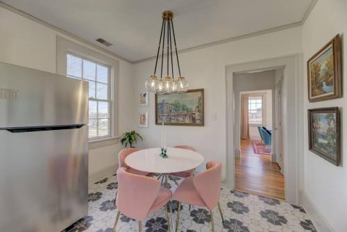 a kitchen and dining room with a table and a refrigerator at The Jewel of Bull St. Upstairs in Columbia