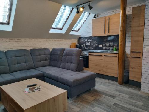 a living room with a couch and a table at Pension Bergstube in Bad Langensalza