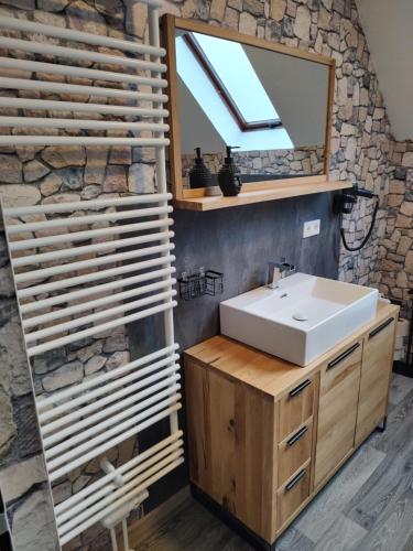 a bathroom with a sink and a mirror at Pension Bergstube in Bad Langensalza