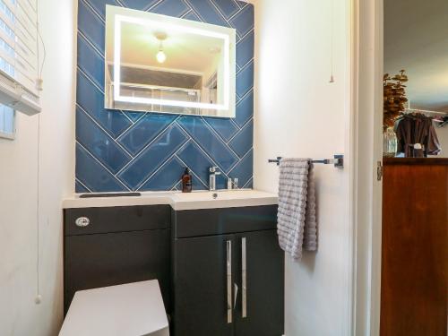 a bathroom with a sink and a mirror at The Lodge at Wildersley Farm in Belper