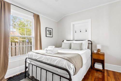 a white bedroom with a bed and a window at West Cola Historic Mill House in West Columbia