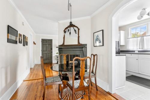 a dining room with a table and a fireplace at West Cola Historic Mill House in West Columbia
