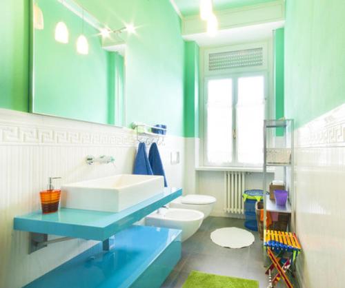 a blue bathroom with a sink and a toilet at Apartment Como 54b in Como