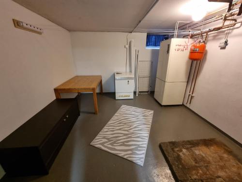 a small room with a table and a refrigerator at Årjäng Villa nära naturen in Årjäng