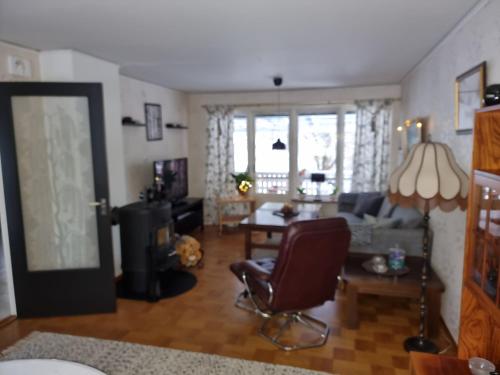 a living room with a couch and a chair at Årjäng Villa nära naturen in Årjäng