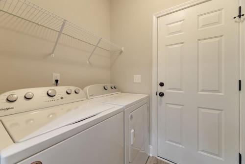 a white laundry room with a washer and dryer at Viva Verde by Heartwood in Cayce