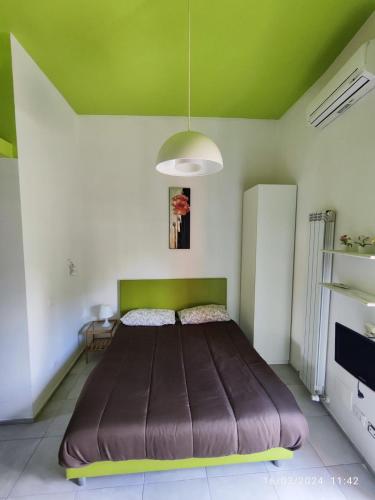 a large bed in a room with a green ceiling at San Lollo Room in Rome