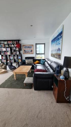a living room with a couch and a coffee table at Calming Sea View City Apartment in Edinburgh