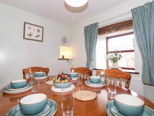 a dining room with a wooden table and chairs at The Stable in Crosby Ravensworth