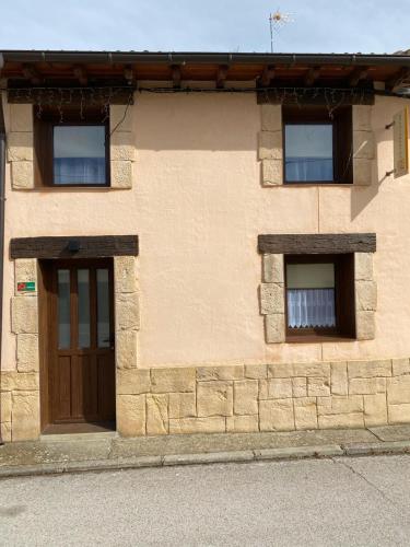 a brick building with a door and two windows at Casa Dakar in Valdemaluque
