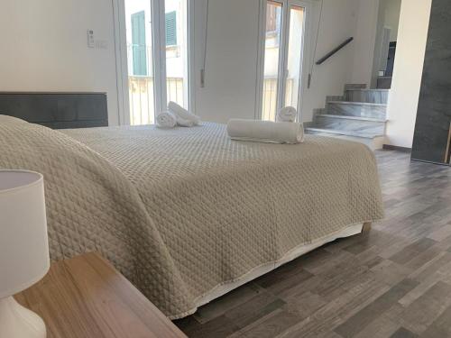 a bedroom with a bed with a brown blanket at Suoru Maria Apartments in Chiaramonte Gulfi