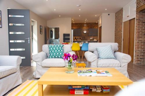 a living room with two couches and a coffee table at The Kennels in Hexham