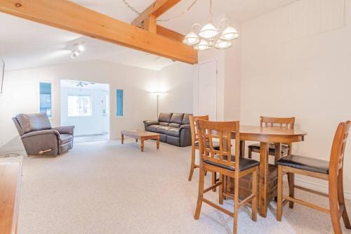 a living room with a table and chairs at Hot Tub Beach Retreat in Grand Bend in Grand Bend
